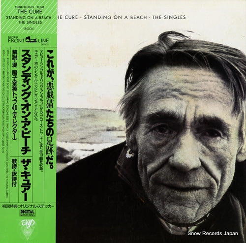 CURE, THE standing on a beach. the singles 35159-25